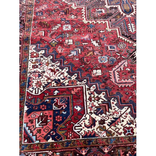 179 - PERSIAN HERIZ CARPET, 333cm x 268cm.