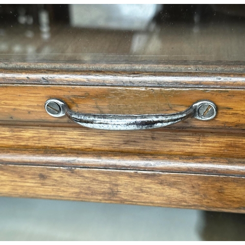 246 - HABERDASHERY CABINET BY DUDLEY & CO, mid 20th century oak with sixteen glazed drawers above two slid... 