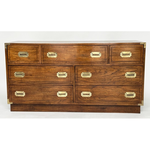 252 - LOW CHEST, campaign style elm and brass bound with seven drawers, 143cm x 46cm x 73cm H.