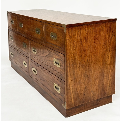 252 - LOW CHEST, campaign style elm and brass bound with seven drawers, 143cm x 46cm x 73cm H.