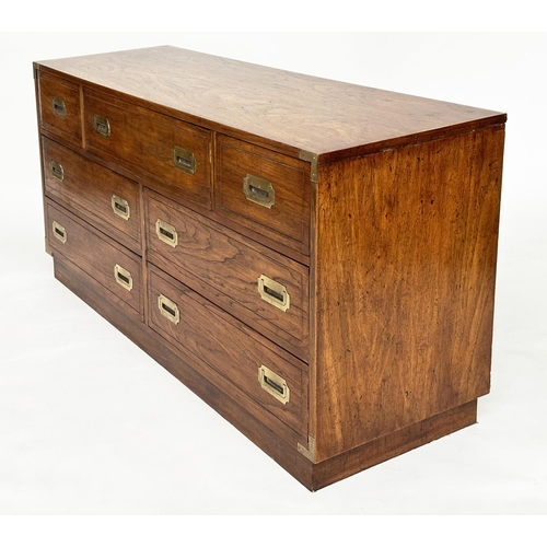 252 - LOW CHEST, campaign style elm and brass bound with seven drawers, 143cm x 46cm x 73cm H.