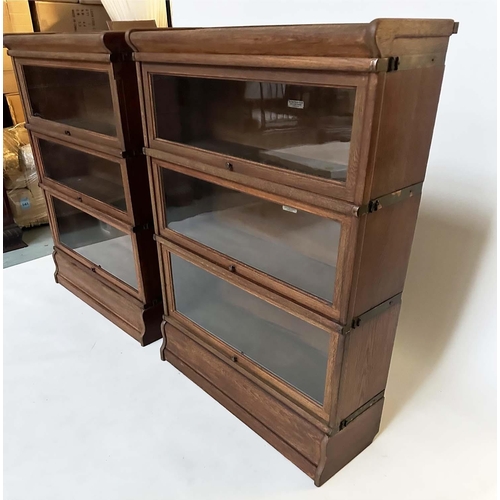 258 - GLOBE WERNICKE BOOKCASES, a pair, early 20th century oak each with three glazed stacking sections, a... 