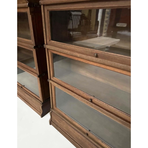 258 - GLOBE WERNICKE BOOKCASES, a pair, early 20th century oak each with three glazed stacking sections, a... 