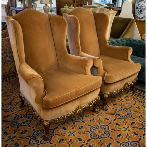 387 - WING ARMCHAIRS, 118cm H x 86cm, a pair, Georgian style in brown velvet on carved gilt heightened leg... 