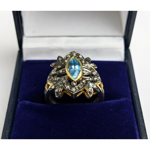 44 - A VICTORIAN STYLE SILVER-GILT TOPAZ DRESS RING, the central stone of 0.30 carats surrounded by tiny ... 