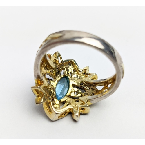 44 - A VICTORIAN STYLE SILVER-GILT TOPAZ DRESS RING, the central stone of 0.30 carats surrounded by tiny ... 