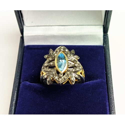 44 - A VICTORIAN STYLE SILVER-GILT TOPAZ DRESS RING, the central stone of 0.30 carats surrounded by tiny ... 