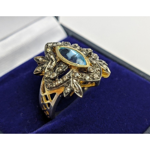 44 - A VICTORIAN STYLE SILVER-GILT TOPAZ DRESS RING, the central stone of 0.30 carats surrounded by tiny ... 