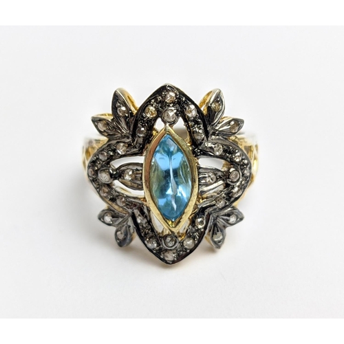 44 - A VICTORIAN STYLE SILVER-GILT TOPAZ DRESS RING, the central stone of 0.30 carats surrounded by tiny ... 