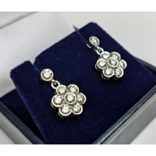 45 - A PAIR OF 18CT WHITE GOLD AND DIAMOND CLUSTER DROPLET EARRINGS, of flower-head design, the diamonds ... 