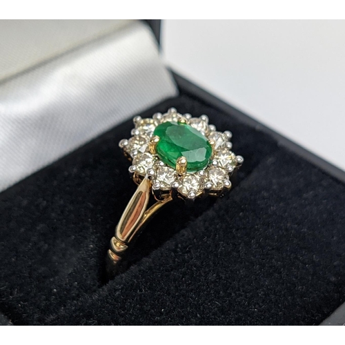 46 - A 9CT GOLD EMERALD AND DIAMOND RING, the central emerald of 0.85 carats surrounded by round brillian... 