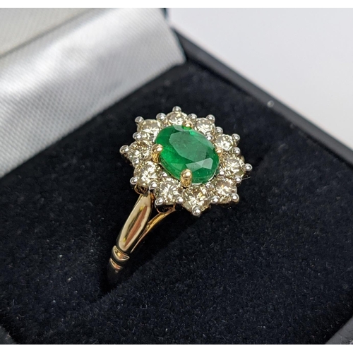 46 - A 9CT GOLD EMERALD AND DIAMOND RING, the central emerald of 0.85 carats surrounded by round brillian... 