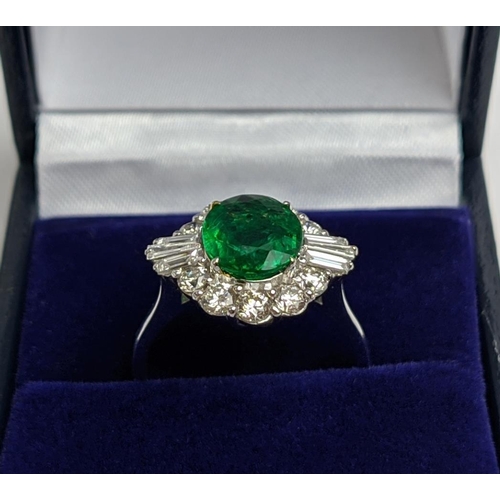 51 - AN 18CT WHITE GOLD EMERALD AND DIAMOND CLUSTER RING, the oval stone of approx. 1.89 carats, surround... 