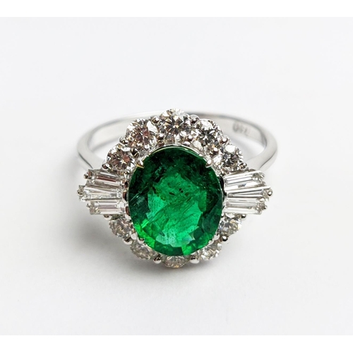 51 - AN 18CT WHITE GOLD EMERALD AND DIAMOND CLUSTER RING, the oval stone of approx. 1.89 carats, surround... 