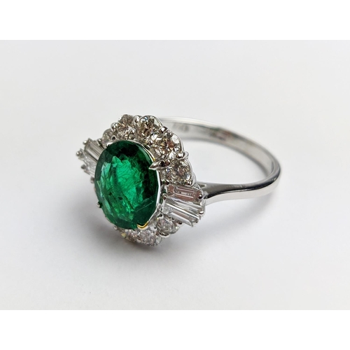 51 - AN 18CT WHITE GOLD EMERALD AND DIAMOND CLUSTER RING, the oval stone of approx. 1.89 carats, surround... 