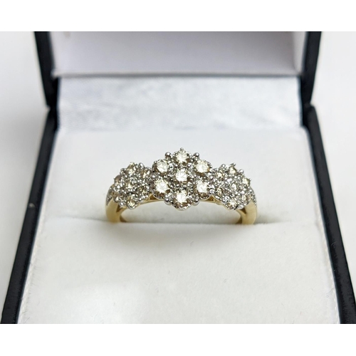 55 - A 9CT YELLOW GOLD DIAMOND CLUSTER DRESS RING, set with three clusters of seven diamonds, total diamo... 