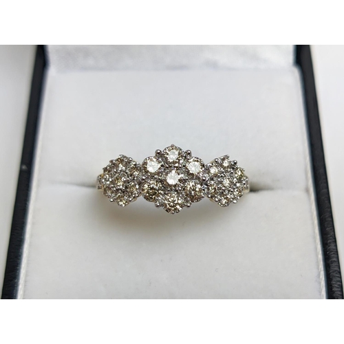 55 - A 9CT YELLOW GOLD DIAMOND CLUSTER DRESS RING, set with three clusters of seven diamonds, total diamo... 