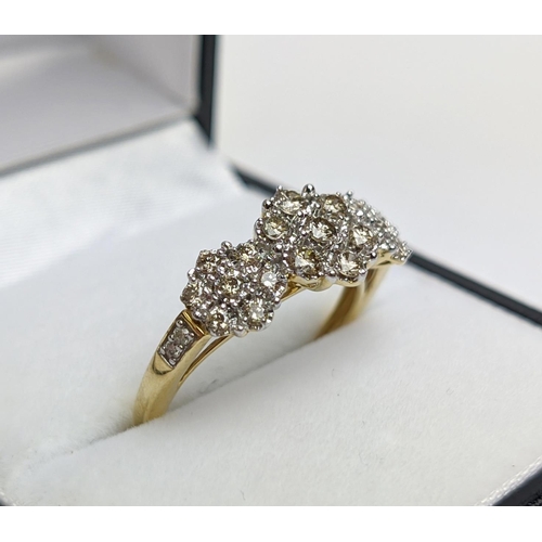 55 - A 9CT YELLOW GOLD DIAMOND CLUSTER DRESS RING, set with three clusters of seven diamonds, total diamo... 