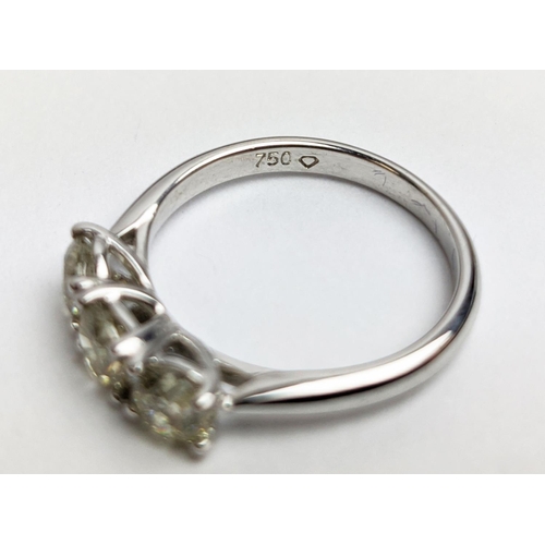 56 - AN 18CT WHITE GOLD THREE STONE DIAMOND TRILOGY RING, the claw set round brilliant cut stones of appr... 