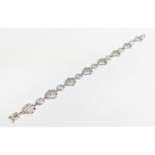 57 - A 9CT WHITE GOLD DIAMOND BRACELET, wave-form, fitted with round cut diamonds totalling 0.20 carats, ... 