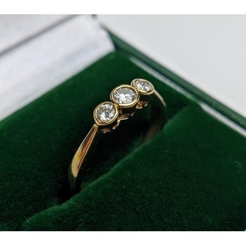 58 - A 9CT YELLOW GOLD THREE STONE DIAMOND TRILOGY RING, set with round brilliant cut stones of approxima... 