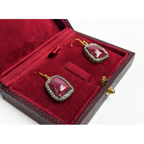 59 - A PAIR OF RUBY AND DIAMOND DROP EARRINGS, the large central stones with an approximate weight of 4.9... 