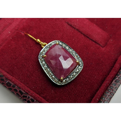 59 - A PAIR OF RUBY AND DIAMOND DROP EARRINGS, the large central stones with an approximate weight of 4.9... 