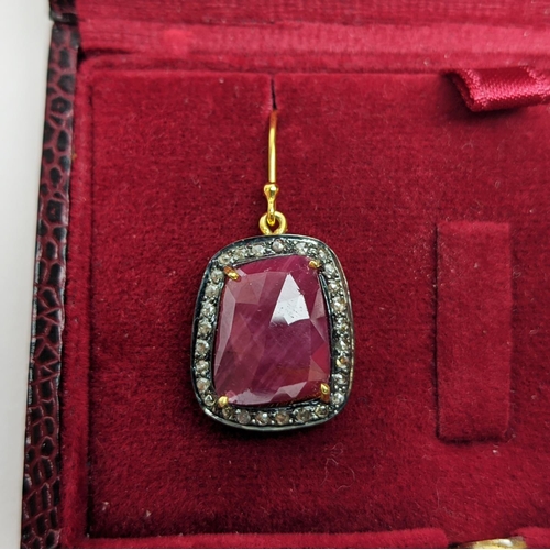 59 - A PAIR OF RUBY AND DIAMOND DROP EARRINGS, the large central stones with an approximate weight of 4.9... 