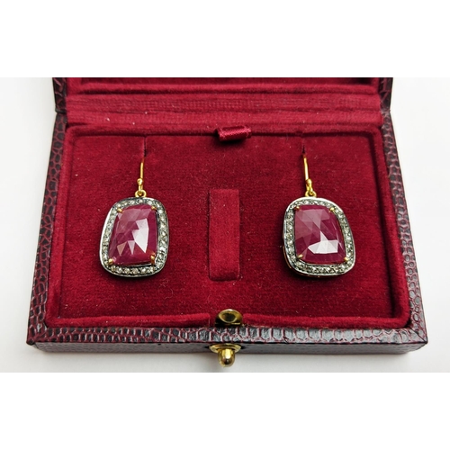 59 - A PAIR OF RUBY AND DIAMOND DROP EARRINGS, the large central stones with an approximate weight of 4.9... 