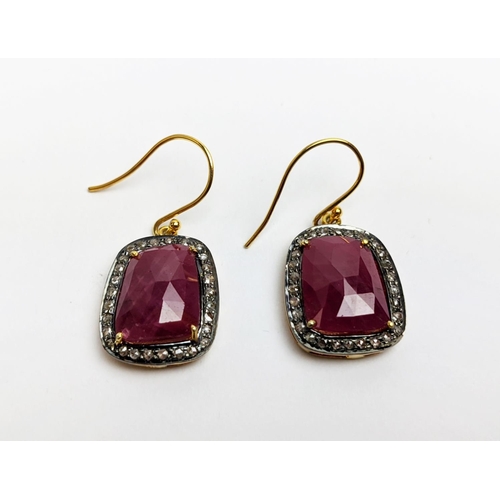 59 - A PAIR OF RUBY AND DIAMOND DROP EARRINGS, the large central stones with an approximate weight of 4.9... 