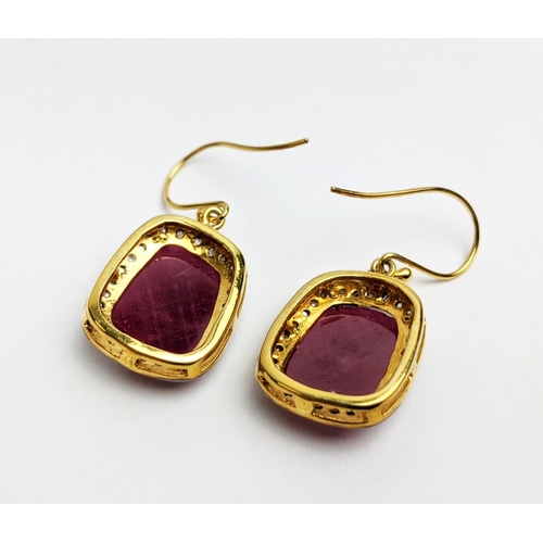 59 - A PAIR OF RUBY AND DIAMOND DROP EARRINGS, the large central stones with an approximate weight of 4.9... 