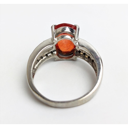 61 - AN 18CT WHITE GOLD ORANGE SAPPHIRE AND DIAMOND SET DRESS RING, the central oval stone of 3.88 carats... 