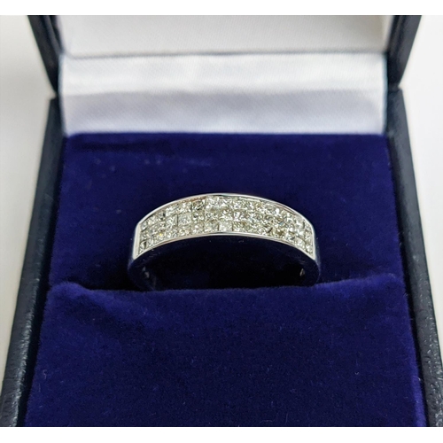 62 - AN 18CT WHITE GOLD DIAMOND RING, with 45 invisible set princess cut diamonds in three rows, total di... 