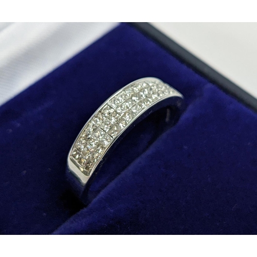 62 - AN 18CT WHITE GOLD DIAMOND RING, with 45 invisible set princess cut diamonds in three rows, total di... 