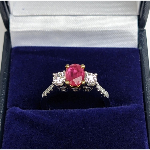 66 - AN 18CT WHITE GOLD RUBY AND DIAMOND TRILOGY RING, the central ruby stone of approx. 0.89 carat, diam... 