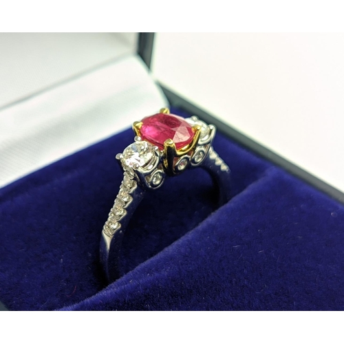 66 - AN 18CT WHITE GOLD RUBY AND DIAMOND TRILOGY RING, the central ruby stone of approx. 0.89 carat, diam... 