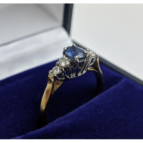 68 - A 9CT YELLOW GOLD SAPPHIRE AND DIAMOND FIVE STONE RING, the central sapphire of 0.50 carat, the diam... 