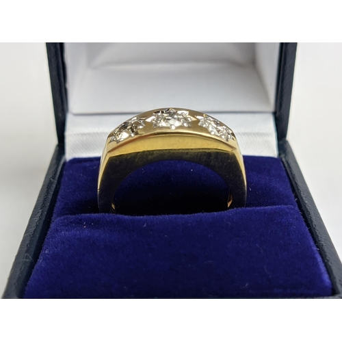 69 - A 9CT YELLOW GOLD GENTS THREE STONE DIAMOND RING, each in a star setting, total diamond weight of 1.... 