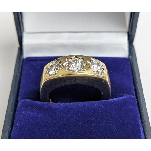 69 - A 9CT YELLOW GOLD GENTS THREE STONE DIAMOND RING, each in a star setting, total diamond weight of 1.... 