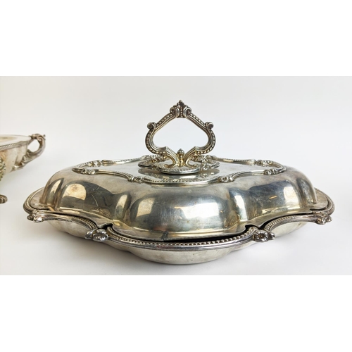 70 - A PAIR OF SILVER PLATED TUREENS AND COVERS, in the Rococo style, plus a pair of warming dishes and t... 