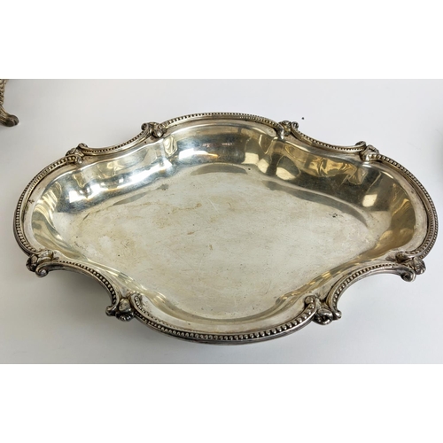 70 - A PAIR OF SILVER PLATED TUREENS AND COVERS, in the Rococo style, plus a pair of warming dishes and t... 