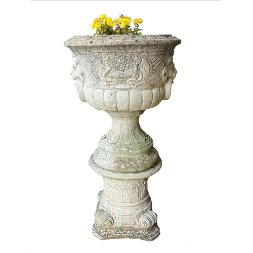 9 - LION HEAD PLANTERS ON STANDS, a pair, well weathered reconstituted stone, 103cm H. (2)