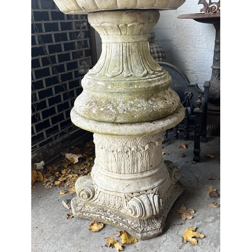 9 - LION HEAD PLANTERS ON STANDS, a pair, well weathered reconstituted stone, 103cm H. (2)