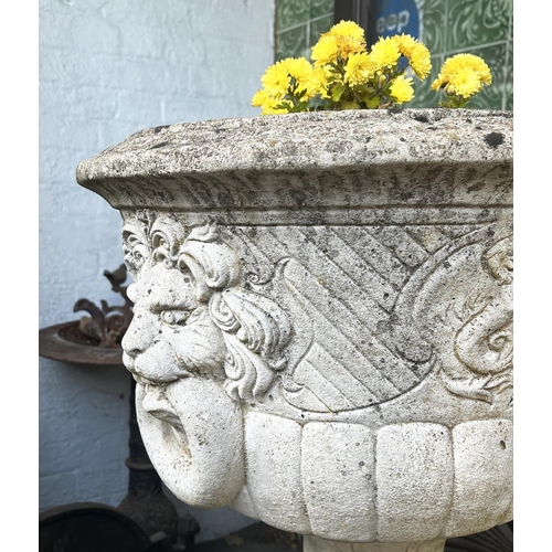 9 - LION HEAD PLANTERS ON STANDS, a pair, well weathered reconstituted stone, 103cm H. (2)