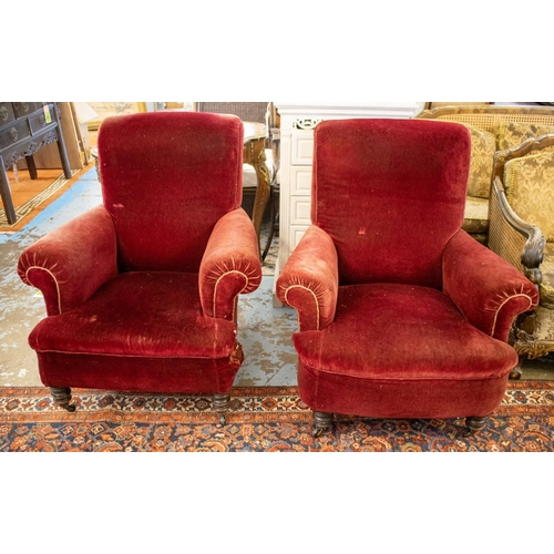 643 - ARMCHAIRS, 94cm H x 86cm W, a pair, late Victorian in old red plush on castors. (2)