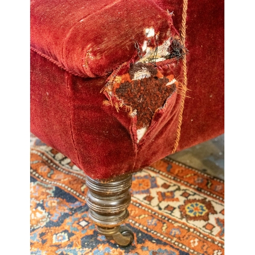 643 - ARMCHAIRS, 94cm H x 86cm W, a pair, late Victorian in old red plush on castors. (2)