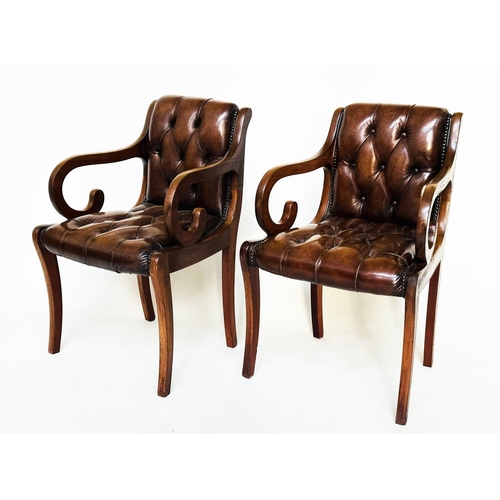 263 - ARMCHAIRS, a pair, Regency style mahogany and brass studded mid brown deep buttoned leather upholste... 