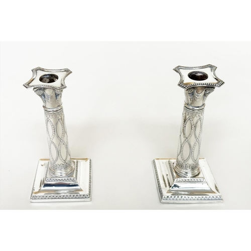 398 - CANDLESTICKS, a pair, George V silver with swag decorated columns and square bases Sheffield 1928 Th... 