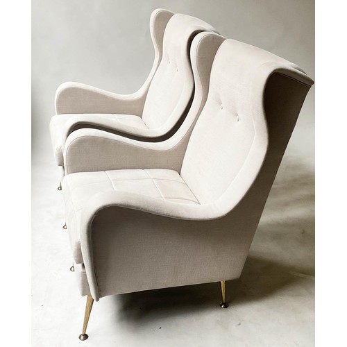 332 - WING ARMCHAIRS, a pair, 1960's style with parchment cotton upholstery and splay gilt metal supports,... 