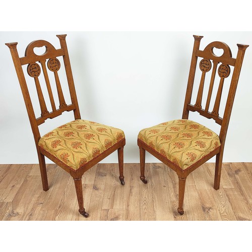 264A - ARTS AND CRAFTS SIDE CHAIRS, a pair, circa 1905 oak the back-splats with carved roundels, overstuffe... 